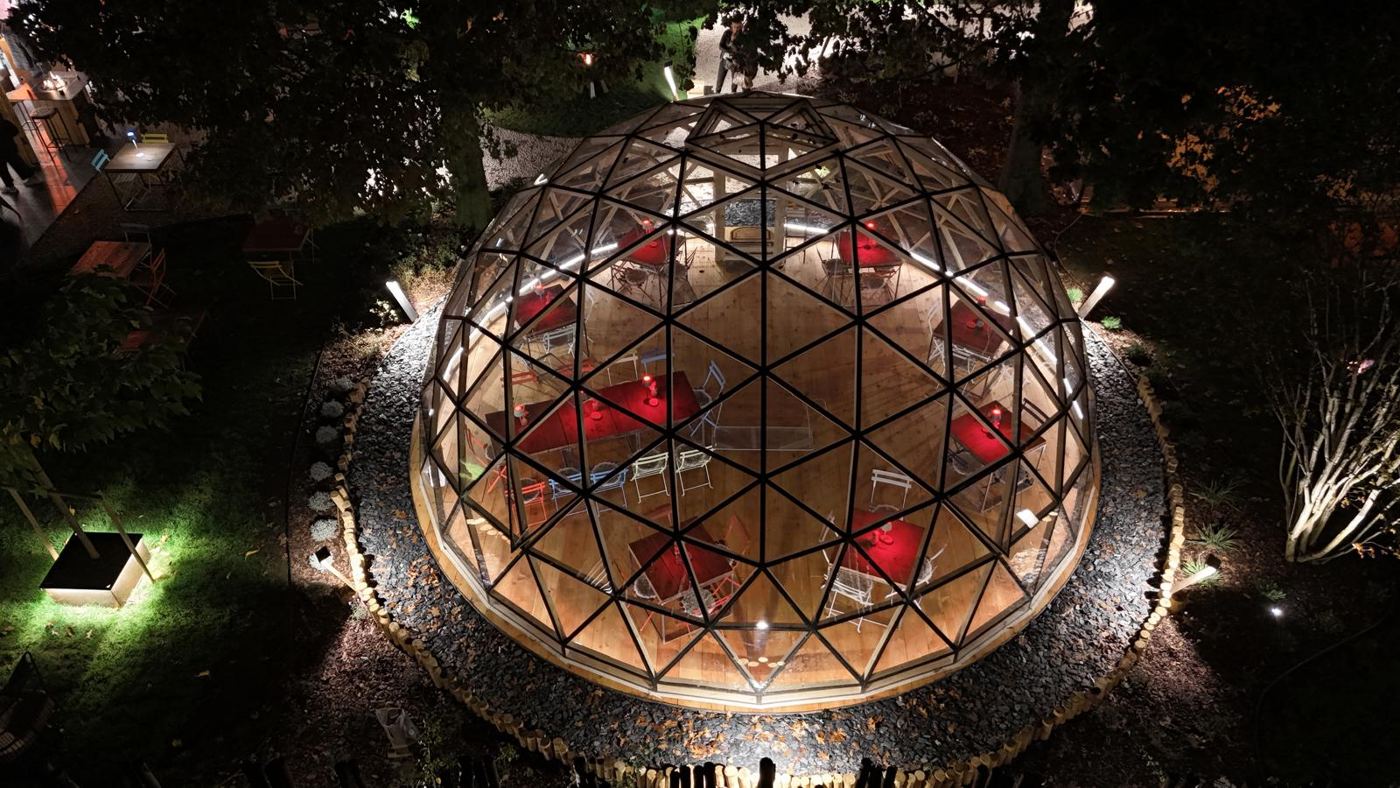 Night aerial of the lantern-lit dome in the garden